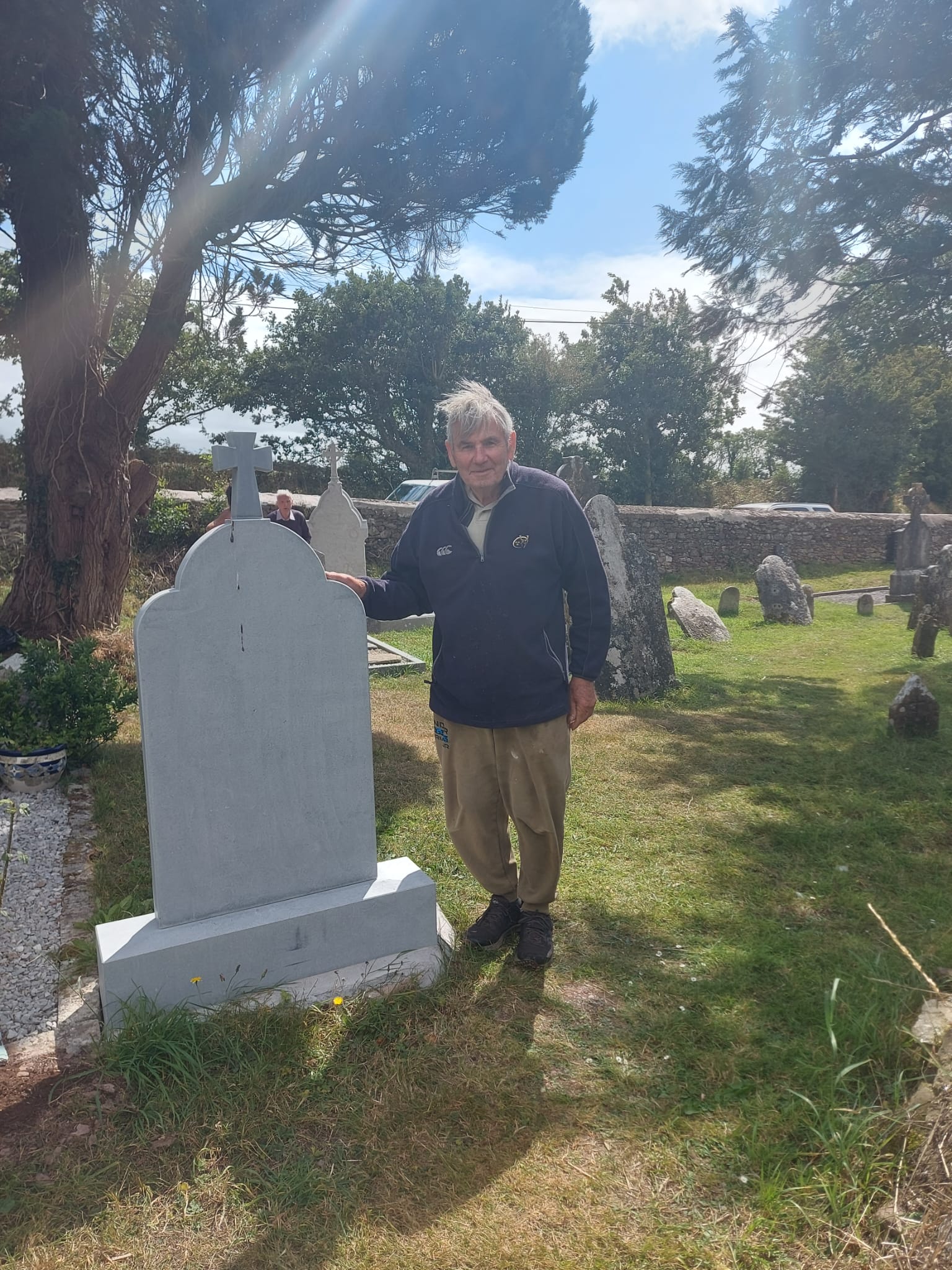 Michael Finn standing next to his plot in Templecurraheen Graveyard